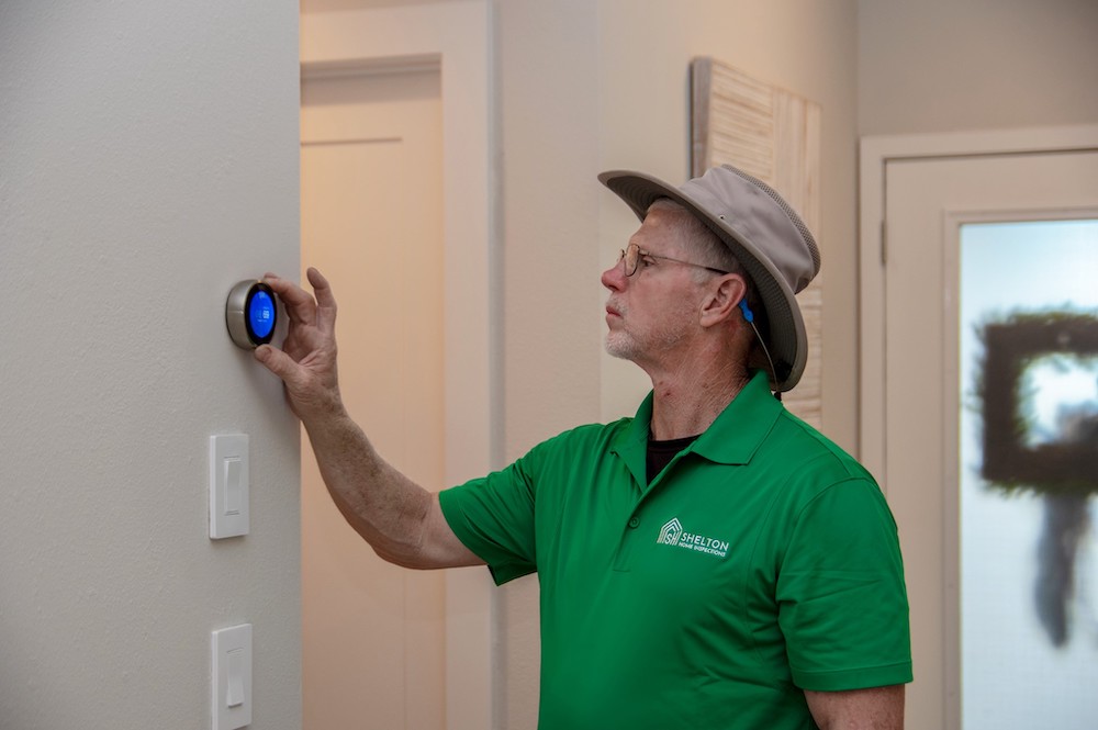 Inspector viewing thermostat